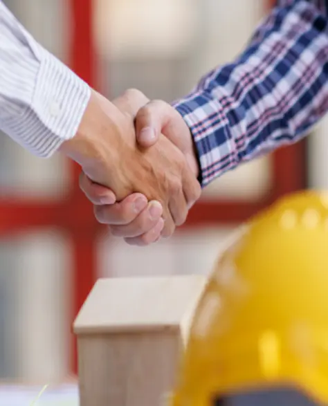 Spray Foam Insulation Contractors in Jackson Heights, NY - Two Men at a Construction Site Shaking Hands