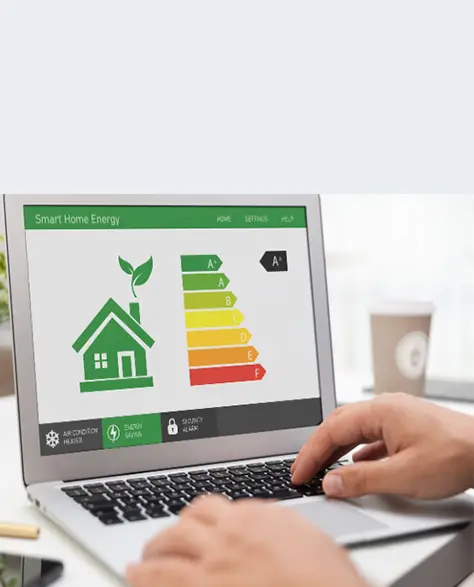 Spray Foam Insulation Contractors in Rego Park, NY - A Man on a Laptop with an Energy Efficiency Icon and Chart Showing