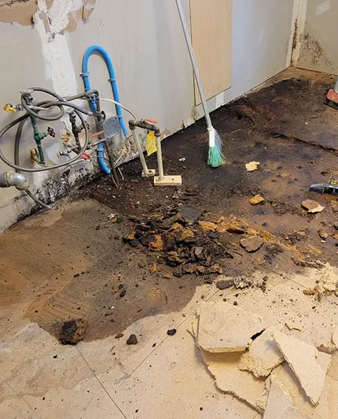 Water Damage Restoration Contractors in East Meadow, NY - Tile Floor Being Repaired from Water Damage<br />
