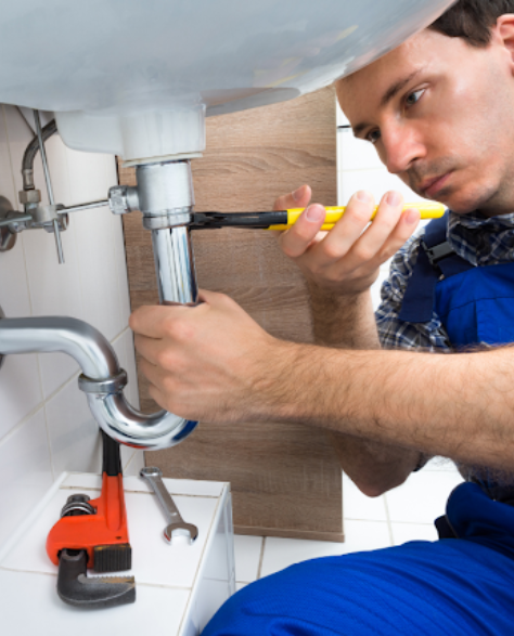 Water Damage Restoration Contractors in Carroll Gardens, NY - A Worker Repairing a Leaky Sink