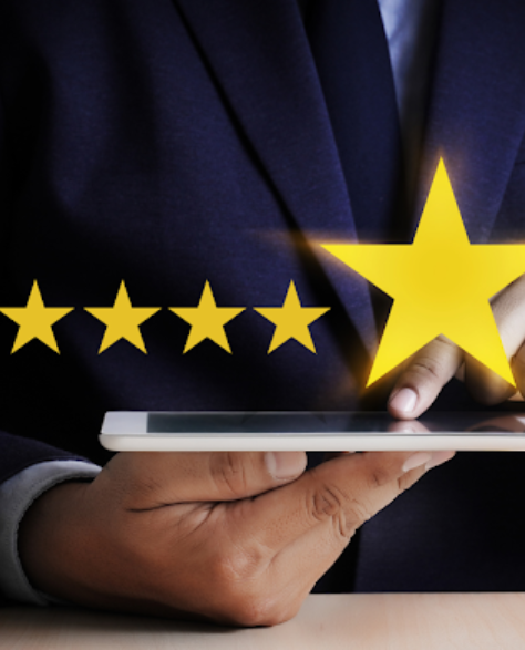 Water Damage Restoration Contractors in Ozone Park, NY - A Man with a White Tablet Touching the Screen and Five Stars Above it in the Air