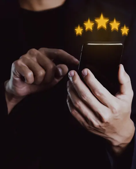 Water Damage Restoration Contractors in Hempstead, NY - A Man Giving a Five-Star Review on His Smartphone with Five Little Gold Star Icons Above It