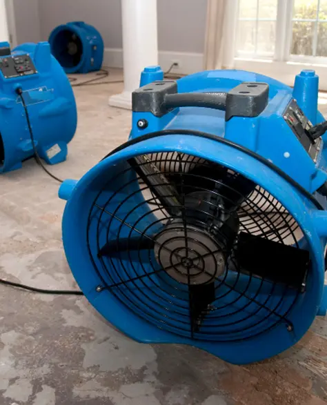 Water Damage Restoration Contractors in Hicksville, NY - Commercial Air Movers Drying a Basement