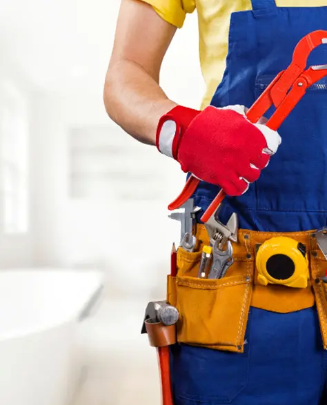 Water Damage Restoration Contractors in Hicksville, NY - A Man with a Tool Pouch Standing in a Bathroom