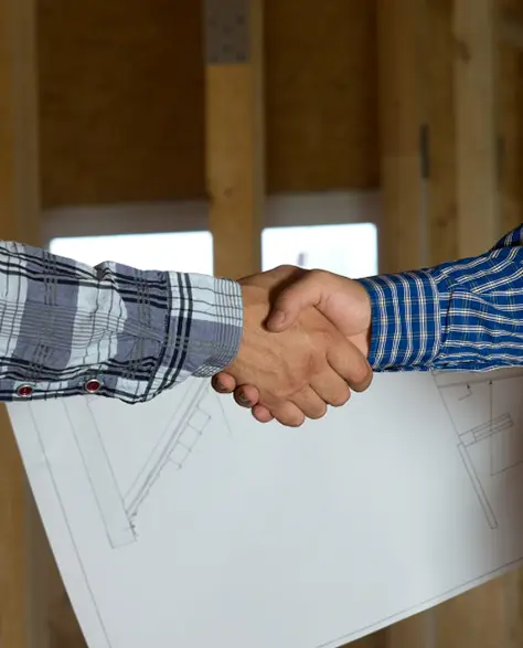 Water Damage Restoration Contractors in Long Beach, NY - Two Men Shaking Hands at a Construction Site