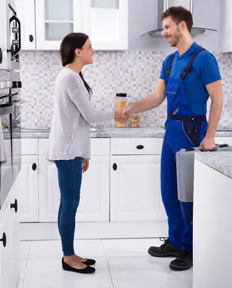 Water Damage Restoration Contractors in Plainview, NY - Water Damage Contractor Shaking Hands with a Homeowner in Her Kitchen<br />
