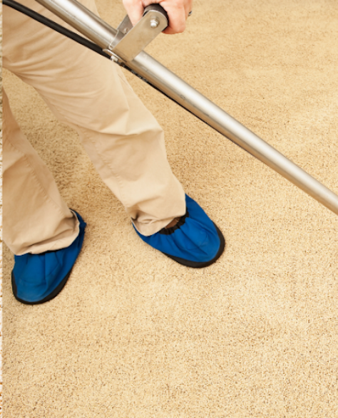 Water Damage Restoration Contractors in Midwood, NY - A Maan Standing on Carpet Vacuuming Water Off of it
