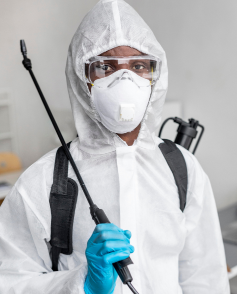 Water Damage Restoration Contractors in Midwood, NY - A Man in a White Protective Suit with a Spray Tank