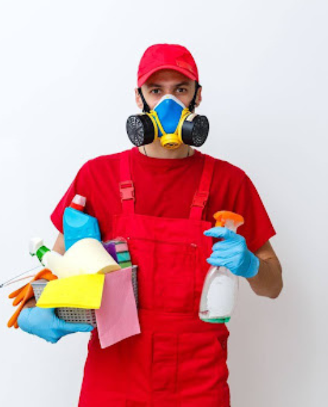 Water Damage Restoration Contractors in Rockville Centre, NY -  A man in overalls and a mask is holding cleaning equipment in both hands.