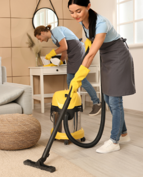 Water Damage Restoration Contractors in Selden, NY - A Woman Vacuuming with a Wet Dry Vac