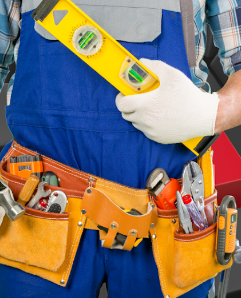 Water Damage Restoration Contractors in Flushing, NY: A contractor in overalls and a tool belt around his waist 