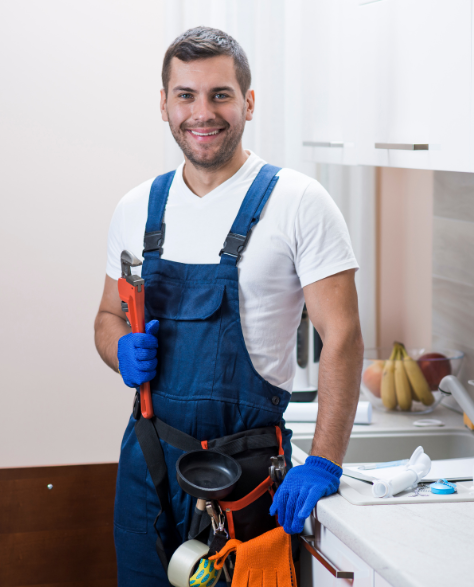 Water Damage Restoration Contractors in Kew Gardens, NY - A Water Damage Restoration Technician Standing in Front of a Kitchen Sink with a Wrench<br />

