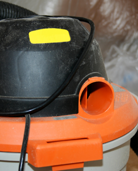 Water Damage Restoration Contractors in Elmhurst, NY - A Wet Dry Vac in a Room with Water on the Floor<br />
