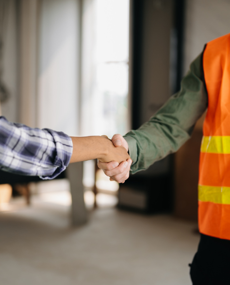 Water Damage Restoration Contractors in Jackson Heights, NY - A worker in a reflective vest and a homeowner is shaking hands<br />
