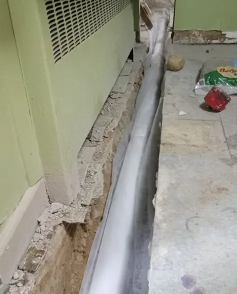 Basement Waterproofing Contractors in Richmond Hill, NY - A Basement with a Section of the Floor Cut Out to Hold PVC from a Sump Pump Installation and Route the Water Outside and Away from the House