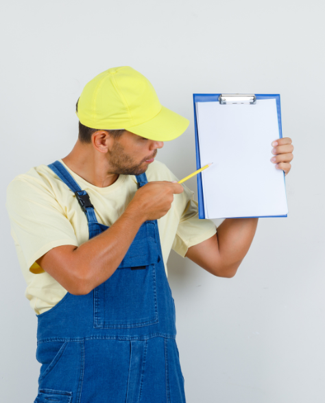 Water Damage Restoration Contractors in Ridgewood, NY - A Man Pointing with a Pen to His Clipboard<br />
