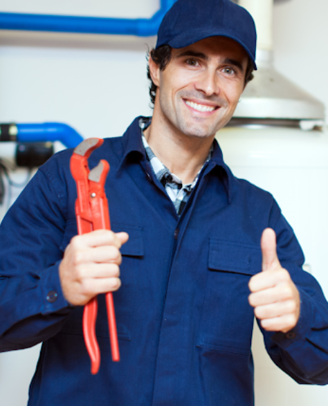 Water damage restoration contractors in Far Rockaway, NY- A man in blue overalls and holding a wrench giving a thumbs up<br />
