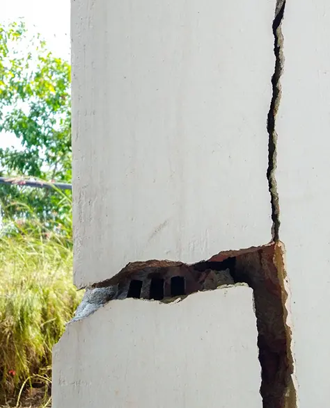 Foundation Repair Contractors in Bellerose, NY - The Corner of a House Foundation with Foundation Cracks