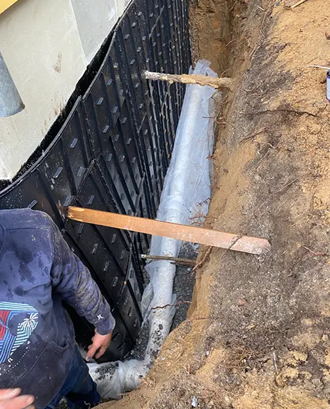 Top-Rated Foundation Repair Contractors in Hicksville, NY - Zavza Seal's Foundation Support Experts Wearing Hoodies with the Zavza Seal Logo On it Tackling a Job in Hicksville, NY