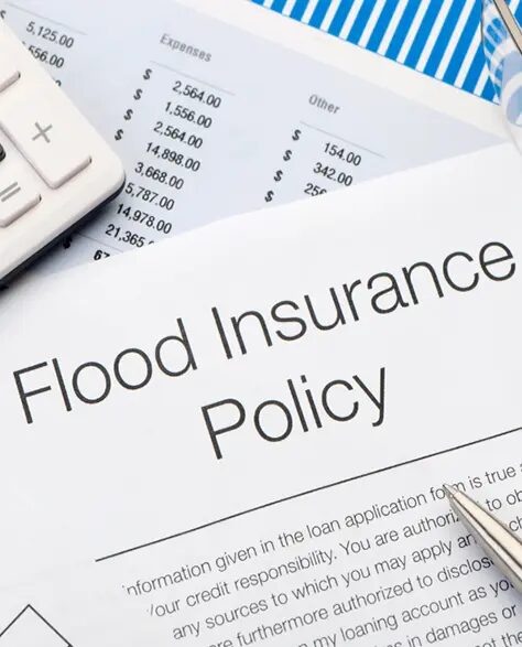 top-rated-water-damage-restoration-contractors-in-Lindenhurst-ny-1.2 Water Damage Restoration Contractors in Lindenhurst, NY - A Paper Showing a Flood Insurance Policy With a Keyword on One Side and a Pen on the Other.