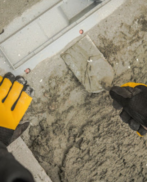 Foundation Repair Contractors in Babylon, NY - A Man Applying Cement to a Foundation<br />
