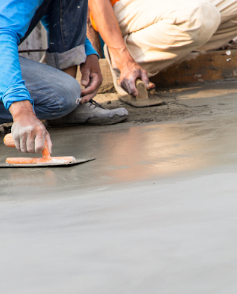 Foundation Repair Contractors in Brentwood, NY - A Man Using a Trowel to Smooth Out Cement<br />
