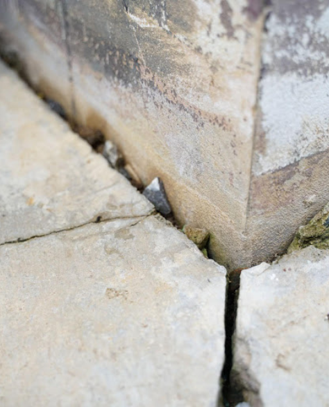 Foundation Repair Contractor in Centereach, NY - A Close-Up Image of a Vertical Foundation Crack Caused by Settling Dirt<br />
