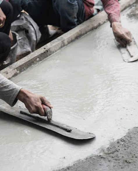 Foundation Repair Contractors in Central Islip, NY - A Man Floating Cement with a Trowel<br />
