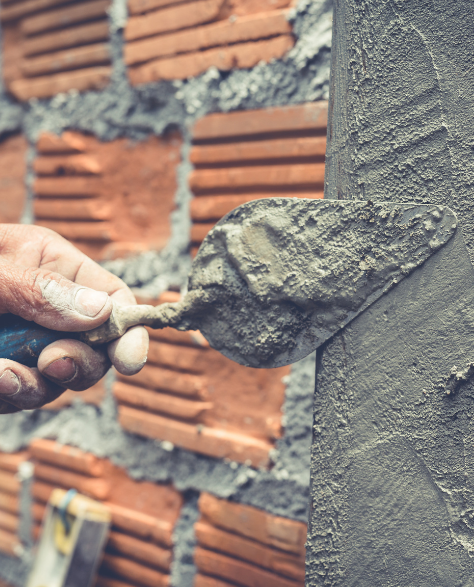 Foundation Repair Contractors in Commack, NY - A Man Fixing a Concrete Foundation<br />
