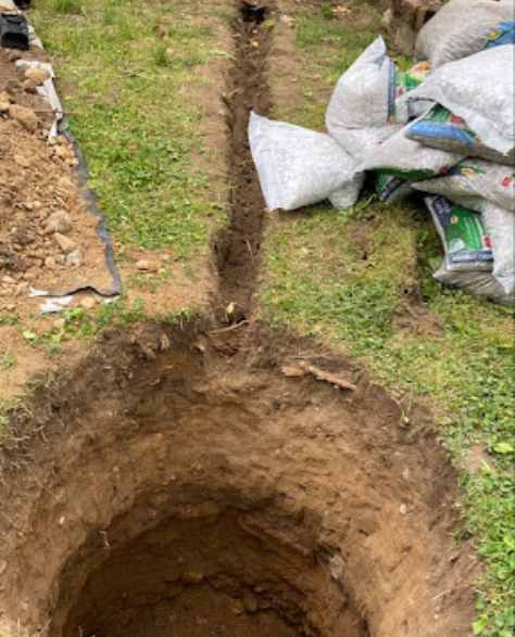 Foundation Repair Contractors in Deer Park, NY - A Hold in the Ground Where a French Drain will be Installed<br />
