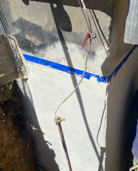 Foundation Repair Contractors in Franklin Square, NY - A Zavza Seal Foundation Repair Specialist in a Zavza Seal Hoodie Working on a Residential Foundation<br />

