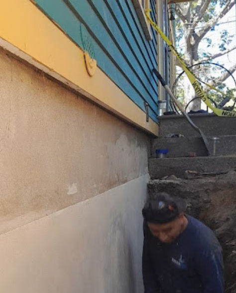 Foundation Repair Contractors in Hauppauge, NY - A Foundation Crack Repair Project Showing Zavza Seal’s Foundation Repair Specialist Wearing a Company Branded Hoodie