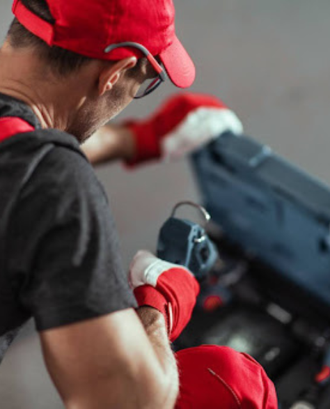 Foundation Repair Contractors in Brooklyn Heights, NY - A Construction Worker Digging in His Toolbox<br />
