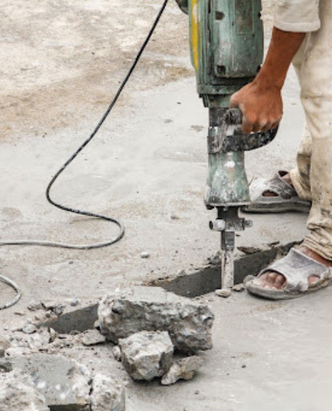 Foundation Repair Contractors in Brooklyn Heights, NY - A Man Fixing a Crack in the Cement<br />
