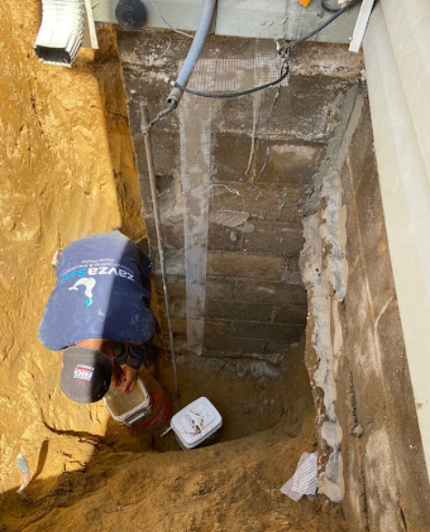 Foundation Repair Contractors in Holbrook, NY - A Zavza Seal Foundation Repair Specialist Working on a Foundation