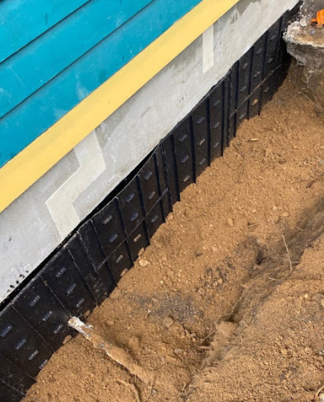 Top-Rated Foundation Repair Contractors in Levittown, NY - A Repaired Foundation with a Skirt Around it<br />
