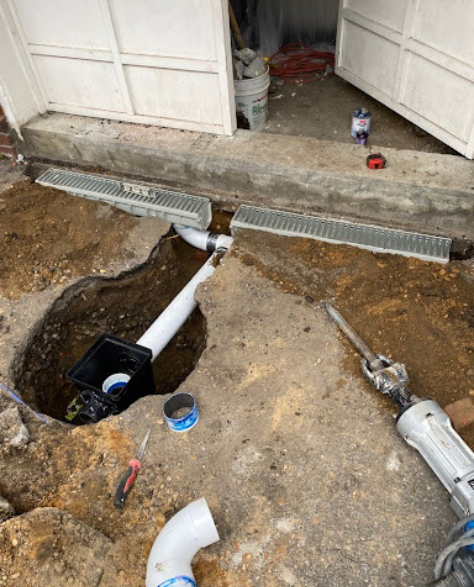 Top-Rated Foundation Repair Contractors in Levittown, NY - A Sump Pump Being Installed on Someone's Property<br />
