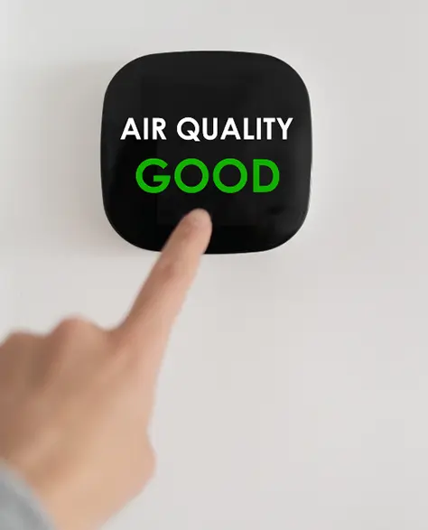 Water Damage Restoration Contractors in Long Island City, NY - A man pressing a button that says, “ Air Quality Good”