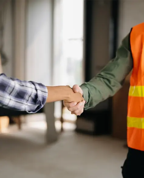 Water Damage Restoration Contractors in South Ozone Park, NY - A Construction Worker Shaking Hands with a Homeowner