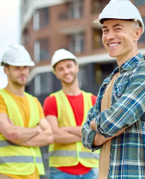 Water Damage Restoration Contractors in South Ozone Park, NY - The construction workers in hard hats smiling 