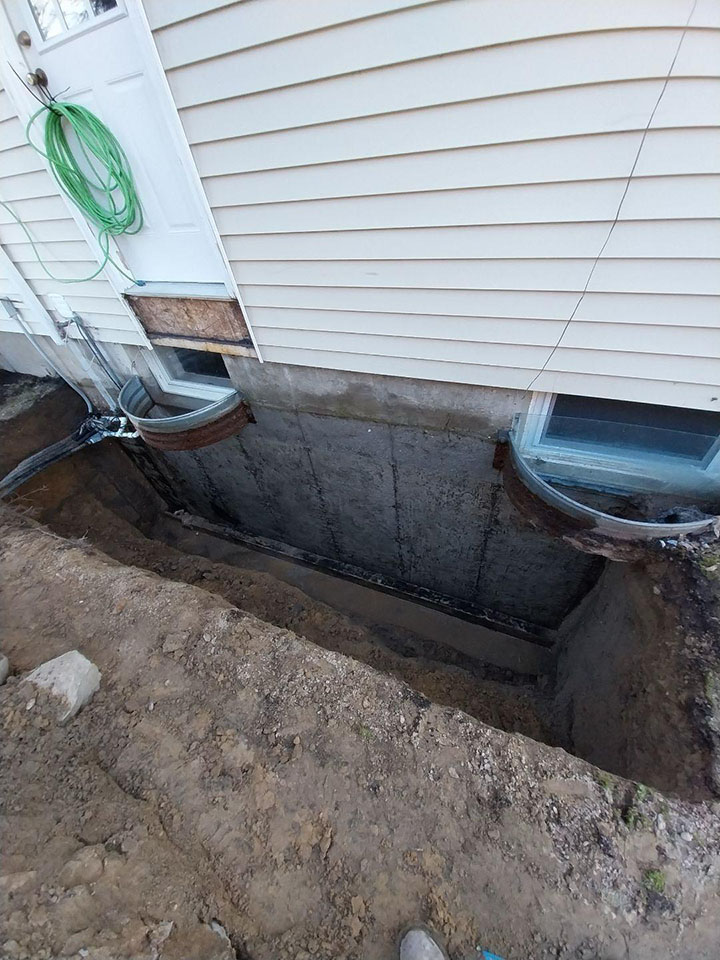 A trench 8 feet deep and 14 feet long dug to waterproof the foundation
