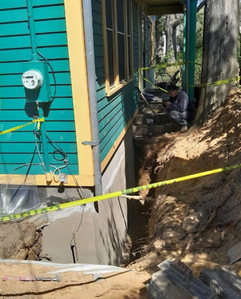 Foundation Repair Contractors in Uniondale, NY - A Foundation Repair Job in Uniondale, NY, with Zavza Seal Foundation Repair Specialists Wearing Company Branded Hoodies<br />
