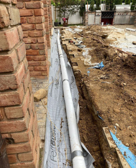 Foundation Repair Contractors in Uniondale, NY - A French Drain Installation by Zavza Seal About Halfway to Completion<br />
