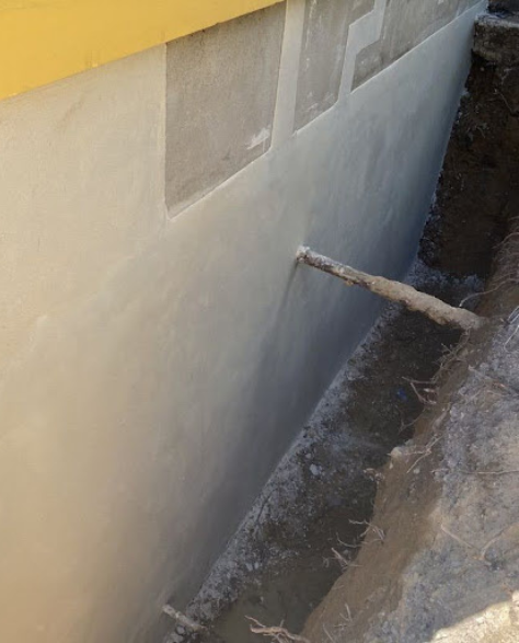 Foundation Repair Contractors in Valley Stream, NY - A Foundation Repair Project Showing a House Foundation with a Trench Dug Around it to Work in<br />

