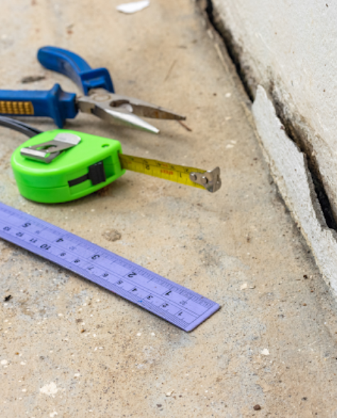 Foundation Repair Contractors in Astoria, NY - A Foundation Crack with Some Tools Beside it<br />
