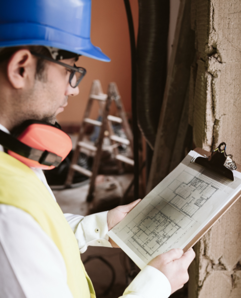 Foundation Repair Contractors in Gowanus, NY - A Foundation Inspector at a House Looking at His Clipboard 