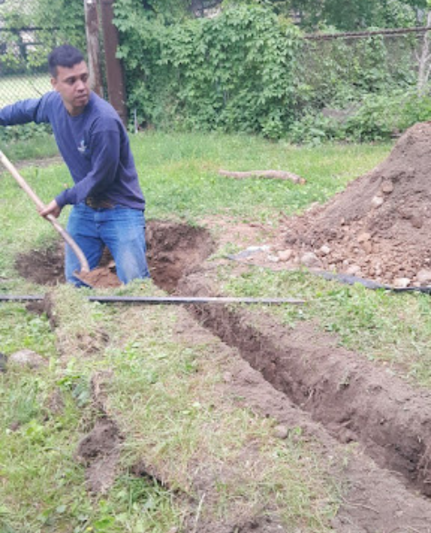  Foundation Repair Contractors in Gowanus, NY - A Foundation Repair Project by Zavza Seal Showing One of the Foundation Repair Techs Digging a Hole for a French Drain<br />
