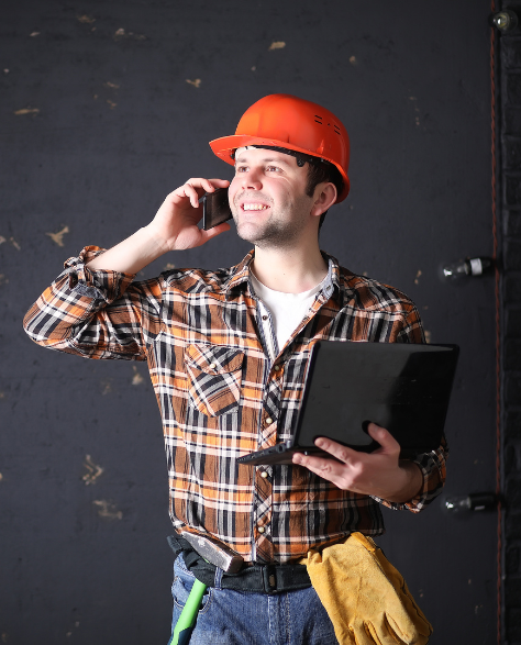 Foundation Repair Contractors in Gravesend, NY - A Foundation Inspector with a Clipboard Talking on His Cell Phone<br />
