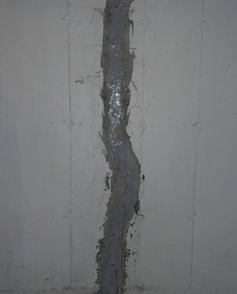 Foundation Repair Contractors in Homecrest, NY - A Picture of a Basement Wall Crack Sealed Up On a Foundation Crack Repair Job<br />
