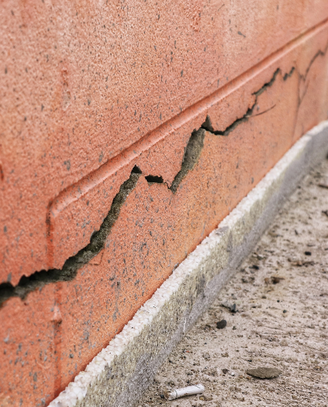 Foundation Repair Contractors in Borough Park, NY - A Foundation Crack Running Down the Side of a Brick Building<br />
